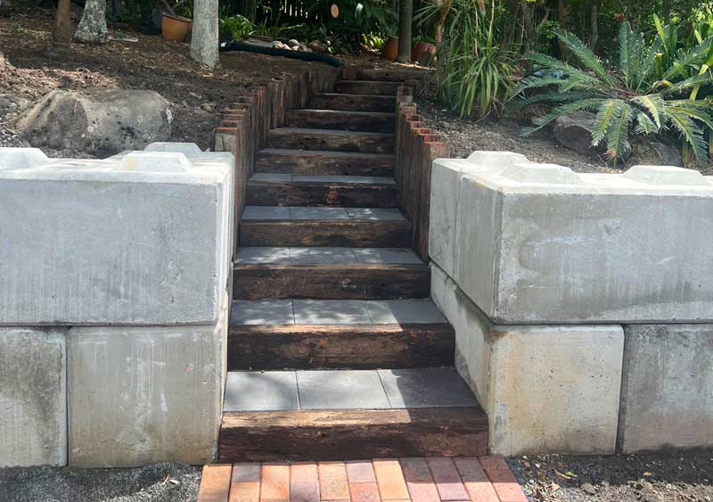 Concrete block retaining wall with timber sleeper steps